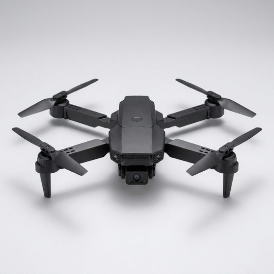 Mini drone con telecamera pieghevole nero in volo sopra un prato
